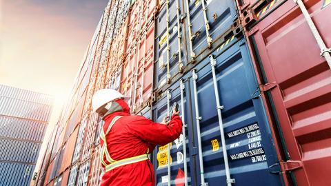 Foreman in front of containers