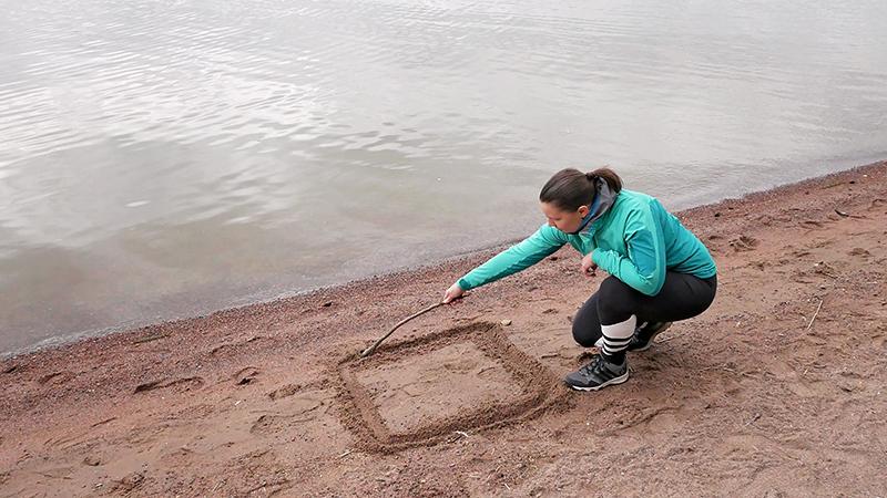 Drawing a square in beach sand