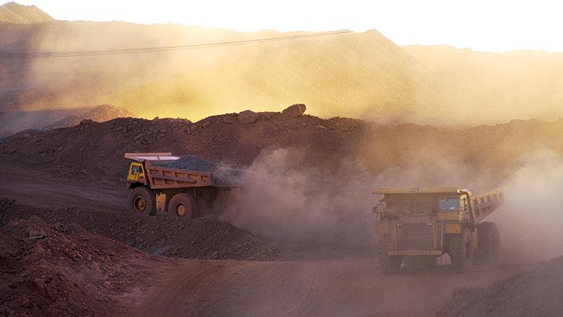 Big trucks working in a dusty mine