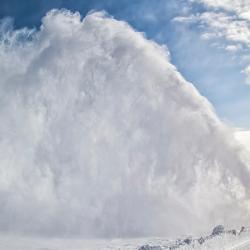 Snow-covered road cleaning by snow removal machine.